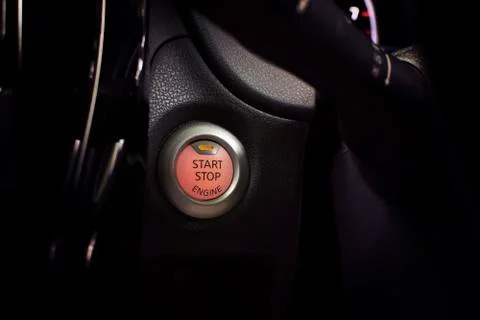 Engine start button of car with a orange light. Foto stock