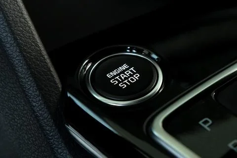 Engine start button in modern car close Stock Photos