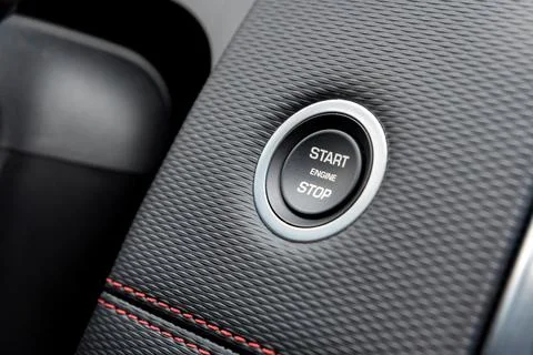 Engine start stop button in modern car close Stock Photos