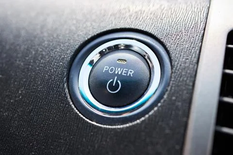 Engine Start Stop power button on modern car. Black leather dashboard air vent Foto stock