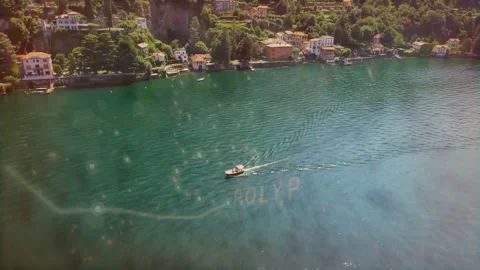Engine starting, small motorboat cruising across lake, leaving V-shaped wake for Stock Footage 334418705
