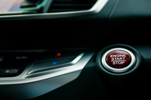 Engine start/stop button in modern car, shallow depth of field Stock Photos