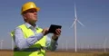Engineer Activity Using Tablet Controlling Wind Turbines Production Capacity 4k or 4k+ Resolution