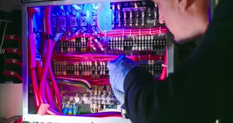 Engineer Adjusting Electrical Panel in Engine Room Stock Footage 323745857