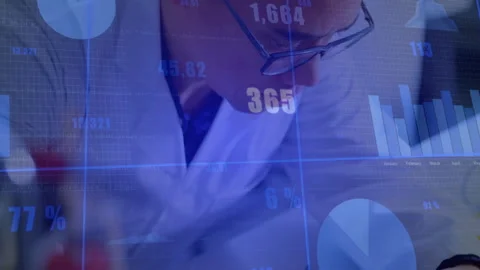 Engineer adjusting probe testing circuit, showing blue data updating Stock Footage 310864513