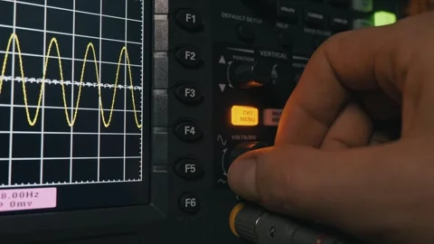 Engineer Adjusting Waveform Signal On Digital Oscilloscope Display Stock-Footage 327854402