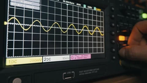 Engineer Adjusting Yellow Sine Wave on Digital Oscilloscope Screen 스톡 동영상 329971929