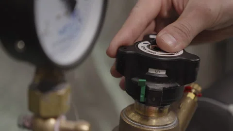 An engineer adjusts the heating system in the control room Stock Footage 306436481
