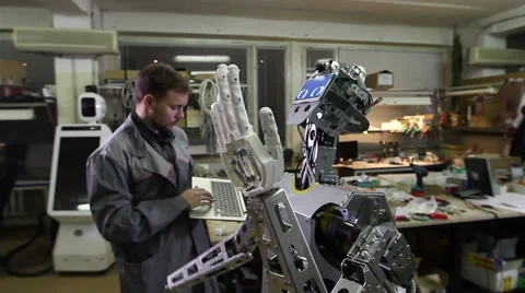 Engineer adjusts the robot Video stock 62023352