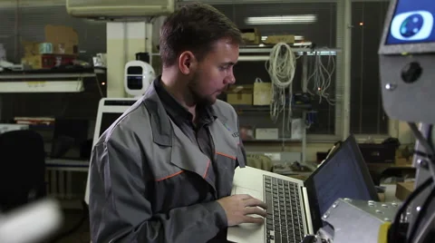 Engineer adjusts the robot Video stock 62023483