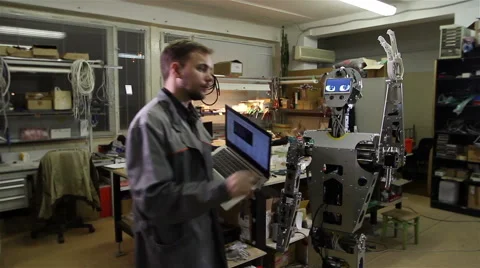Engineer adjusts the robot Video stock 62023860