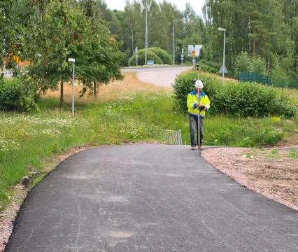 Engineer aligning the road with a theodolite tool Stock Photos