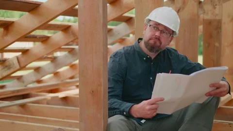 Engineer analyzing a blueprint on a construction site. Stock Footage 315421281