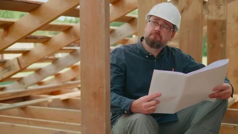 Engineer analyzing a blueprint on a construction site. Stock Footage 316885552