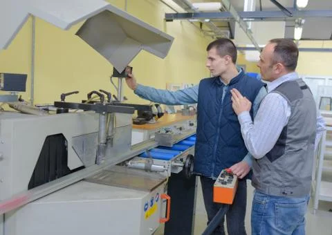 Engineer and apprentice in factory Stock Photos