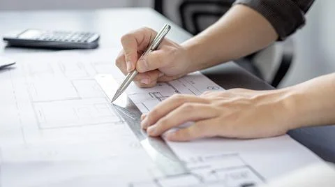 Engineer and Architect concept, Man uses a ruler to measure the floor plan on Stock Photos