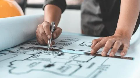 Engineer and Architect concept, Man uses a ruler to measure the floor plan on Stock Photos