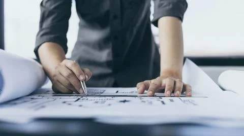 Engineer and Architect concept, Man uses a ruler to measure the floor plan on Stock Photos