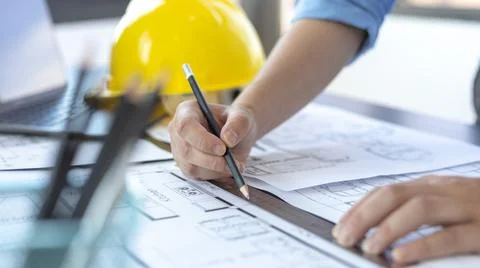 Engineer and Architect concept, Man uses a ruler to measure the floor plan on Stock Photos