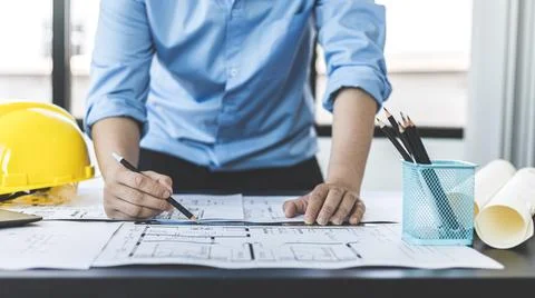 Engineer and Architect concept, Man uses a ruler to measure the floor plan on Stock Photos