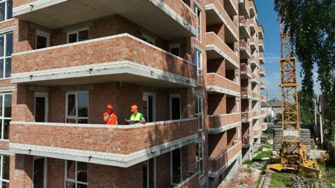 An engineer and an architect consider the plan of construction and Video stock 247326878