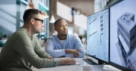 Engineer And Architect Discuss 3D Building Design Using BIM Software Together Stock Photos