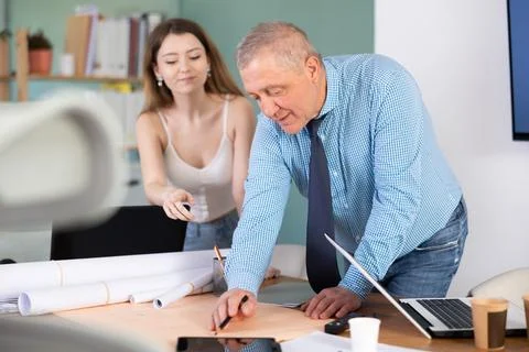 Engineer and architect discussing about blueprint layout design of electricity Stock Photos