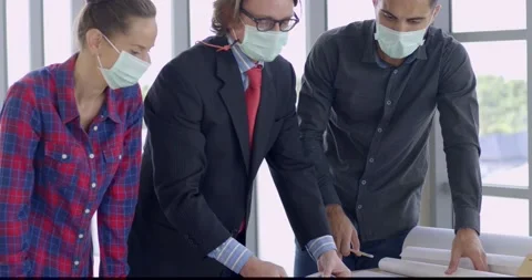 Engineer and architect manager wearing face mask planning on table Stock Footage 143956233