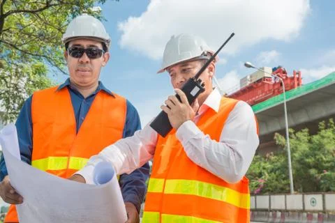 Engineer and Architect or Foreman wear white hardhat and Glow safety cloth me Foto stock
