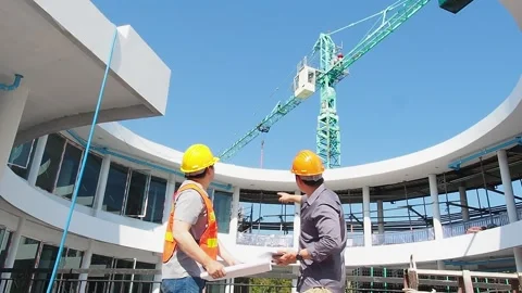 Engineer and architect standing in front of mechanical crane. Stock Footage 242904123