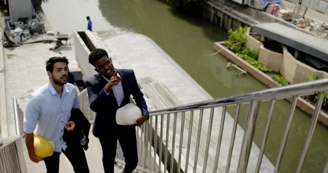 Engineer and architect talking and inspect construction site on edge of city Stock-Footage 169940341