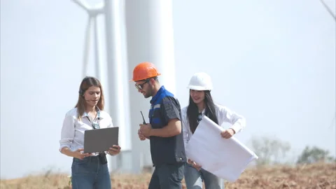 Engineer and Architect working on construction site with wind turbine Stock Footage 264132139