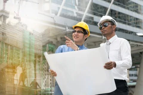Engineer and Architect working at Construction Site with blueprint Stock Photos