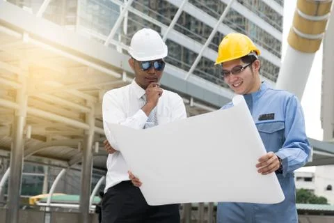 Engineer and Architect working at Construction Site with blueprint Foto stock