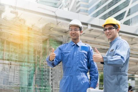 Engineer and Architect working at Construction Site with blueprint Stock Photos