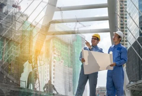 Engineer and Architect working at Construction Site with blueprint Stock Photos