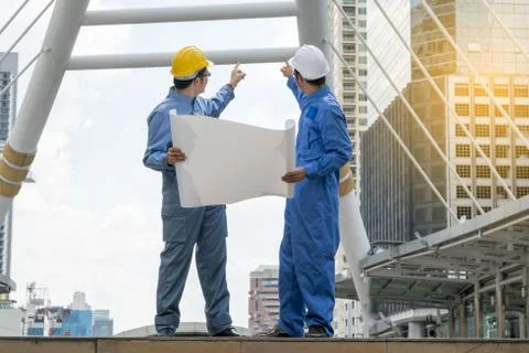 Engineer and Architect working at Construction Site with blueprint Stock Photos
