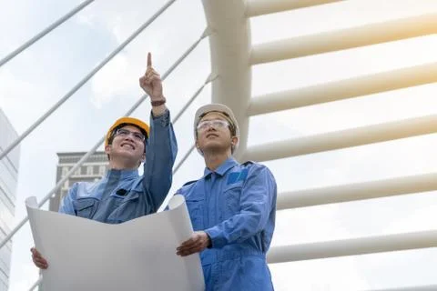Engineer and Architect working at Construction Site with blueprint Stock Photos
