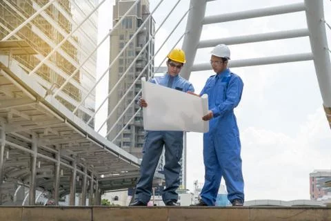 Engineer and Architect working at Construction Site with blueprint Stock Photos