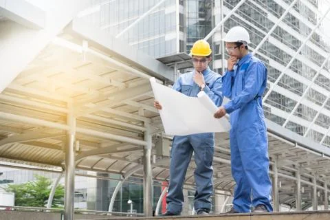 Engineer and Architect working at Construction Site with blueprint Stock Photos
