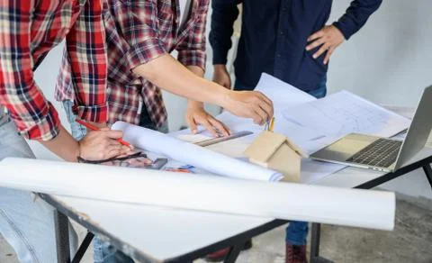 Engineer and architects working and discussing at construction site.  Stock Photos