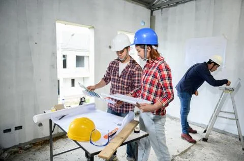 Engineer and architects working and discussing at construction site. Фото
