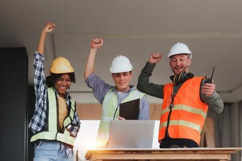 Engineer and Architecture and Foreman celebrate success at construction site Foto stock
