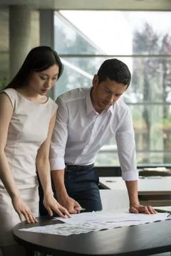 Engineer and associate working closely together on project Stock Photos