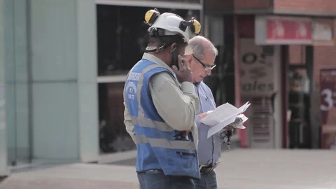 An engineer and a builder checking a plane on the street Stock Footage 95399598