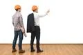 The engineer and a businessman gesture on the white wall background Photo
