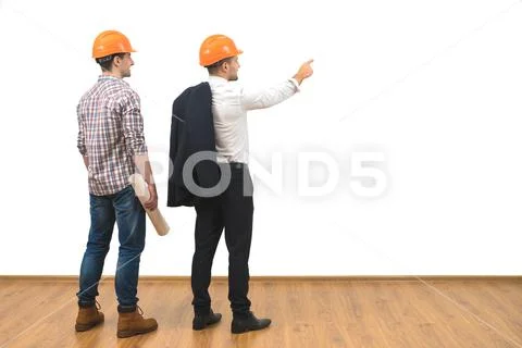 The engineer and a businessman gesture on the white wall background Stock Photos