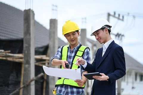 Engineer and businessman planning development details about project at Stock Photos