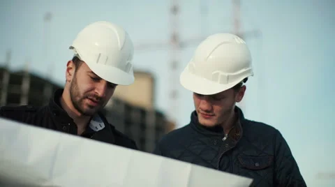 Engineer and client looking on project on the construction site Stock Footage