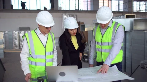 Engineer and client looking on project on the construction site. 4 k airduct of Stock Footage 85822785